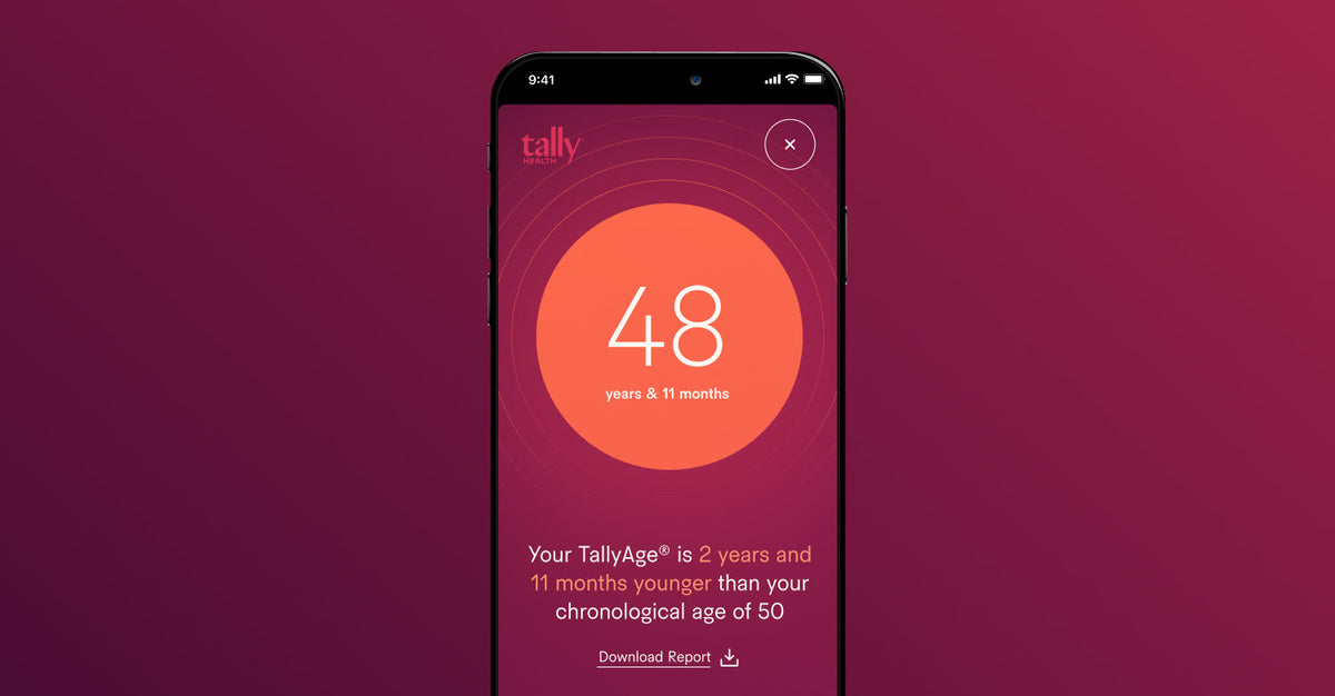 A smartphone screen displaying a TallyAge report showing “48 years & 11 months,” with a note that it’s younger than the person’s chronological age.