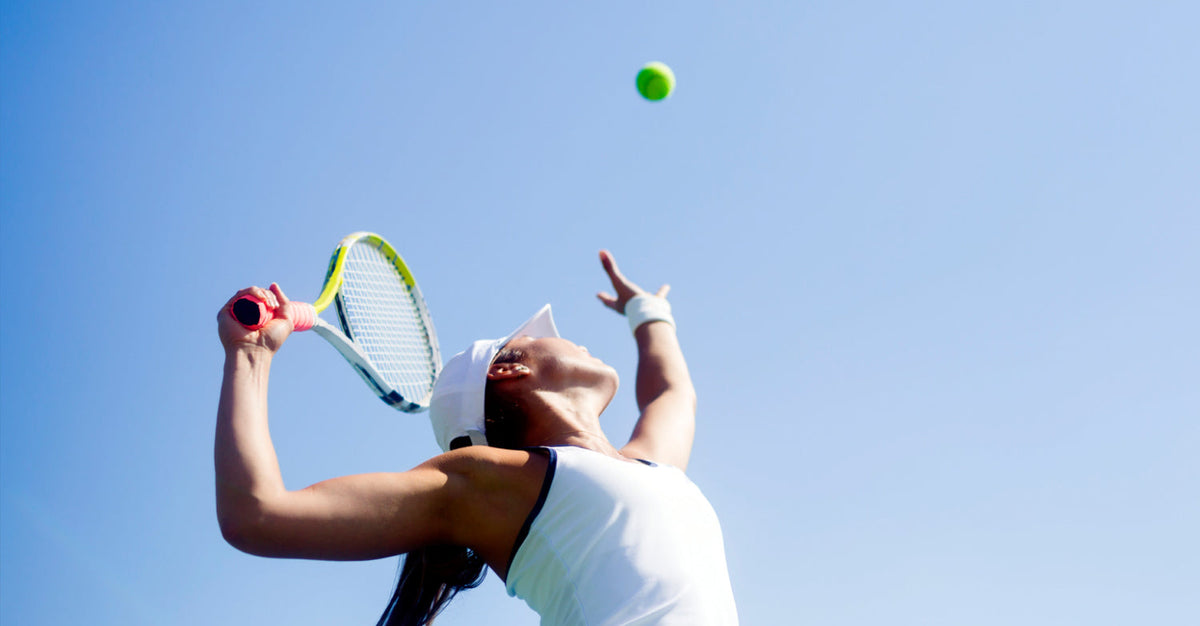 Athlete serving a tennis ball outdoors, illustrating how regular exercise supports healthy aging.