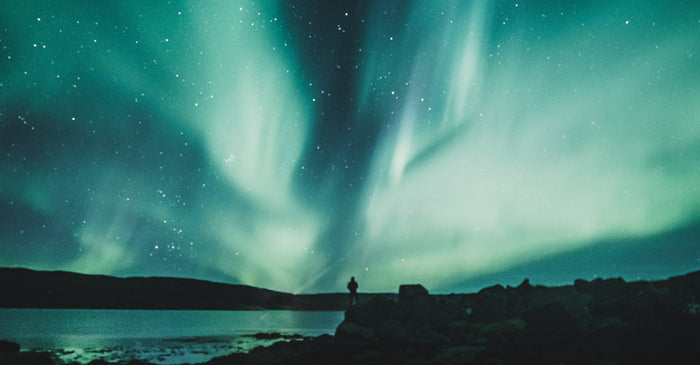 Person standing under the Northern Lights.